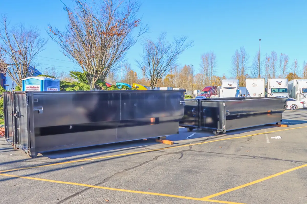 Professional dumpster rental service with roll-off container on residential driveway in South Fayette